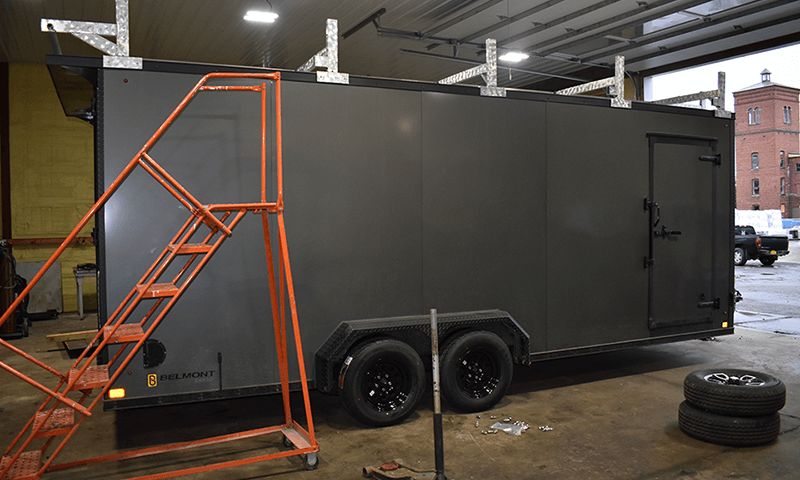 gray trailer covered next to ladder